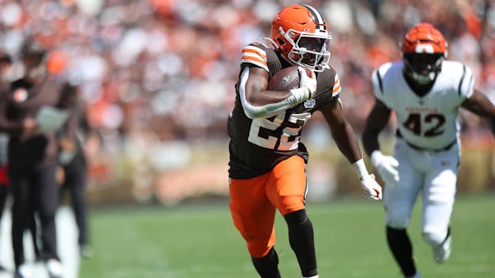 Sep 7, 2025; Cleveland, Ohio, USA; Cleveland Browns running back Dylan Sampson (22) runs against Cincinnati Bengals linebacker Oren Burks (42) during the first half at Huntington Bank Field. Mandatory Credit: Scott Galvin-Imagn Images