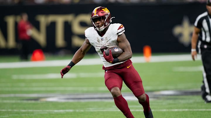 Dec 15, 2024; New Orleans, Louisiana, USA; Washington Commanders running back Brian Robinson Jr. (8) runs against the New Orleans Saints during the first half at Caesars Superdome. Mandatory Credit: Matthew Hinton-Imagn Images