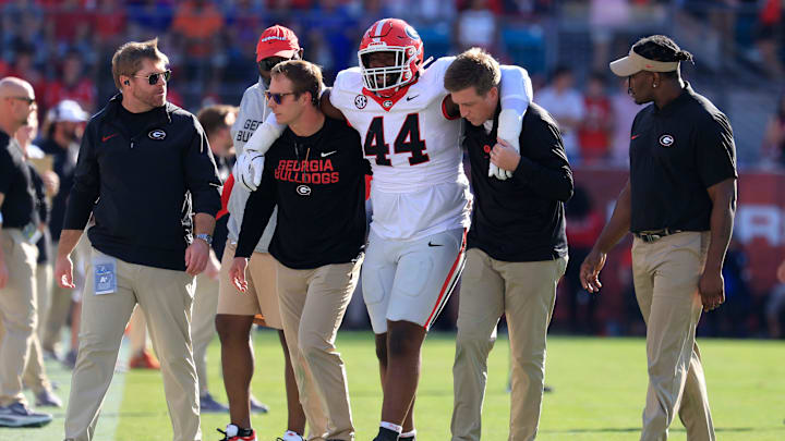defensive lineman Jordan Hall (44) is helped off the field during the first quarter of an NCAA football game, Saturday, Nov. 1, 2025, at EverBank Stadium in Jacksonville, Fla. [Corey Perrine/Florida Times-Union]