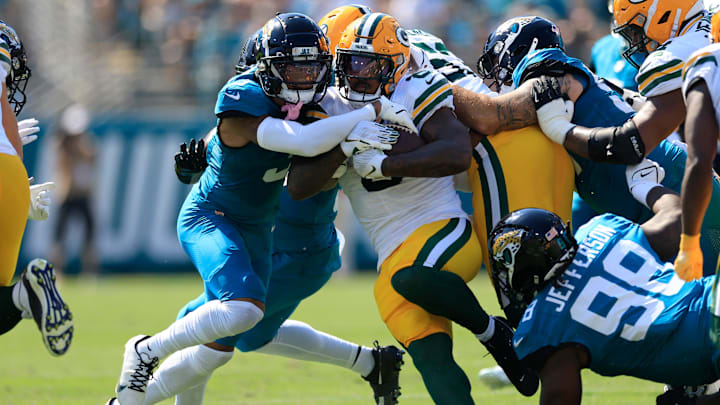Green Bay Packers running back Josh Jacobs (8) rushes for yards against Jacksonville Jaguars cornerback Tyson Campbell (3) during the first quarter of an NFL football matchup Sunday, Oct. 27, 2024 at EverBank Stadium in Jacksonville, Fla. The Packers edged the Jaguars 30-27 on a last-second field goal. [Corey Perrine/Florida Times-Union]