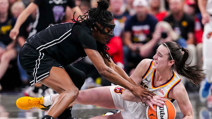 Golden State Valkyries guard Tiffany Hayes (15) and Indiana Fever guard Caitlin Clark (22) fight for the ball Wednesday, July 9, 2025, during a game between the Indiana Fever and the Golden State Valkyries at Gainbridge Fieldhouse in Indianapolis.