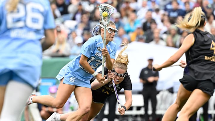 May 25, 2025; Foxborough, MA, USA; North Carolina Tar Heels midfielder Kate Levy (13) drives through Northwestern Wildcats midfielder Sam Smith (19) to the net during the second half at Gillette Stadium. Mandatory Credit: Eric Canha-Imagn Images