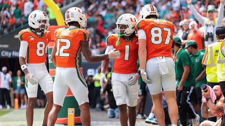 Oct 24, 2026; Miami Gardens, Florida, USA; Miami Hurricanes wide receiver Malachi Toney (1) celebrates with wide receiver Somourian Wingo (12), tight end Gavin Mueller (87) and wide receiver Vandrevius Jacobs (8) after scoring a touchdown against the Pittsburgh Panthers during the second quarter at Hard Rock Stadium. Mandatory Credit: Sam Navarro-Imagn Images Oct 24, 2026; Miami Gardens, Florida, USA; Miami Hurricanes wide receiver Malachi Toney (1) celebrates with wide receiver Somourian Wingo (12), tight end Gavin Mueller (87) and wide receiver Vandrevius Jacobs (8) after scoring a touchdown against the Pittsburgh Panthers during the second quarter at Hard Rock Stadium. Mandatory Credit: Sam Navarro-Imagn Images
