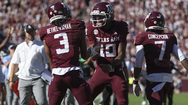 Nov 15, 2025; College Station, Texas, USA; Texas A&M Aggies quarterback Marcel Reed (10) celebrates with wide receiver Ashton Bethel-Roman (3) after a touchdown during the third quarter against the South Carolina Gamecocks at Kyle Field. Mandatory Credit: Troy Taormina-Imagn Images