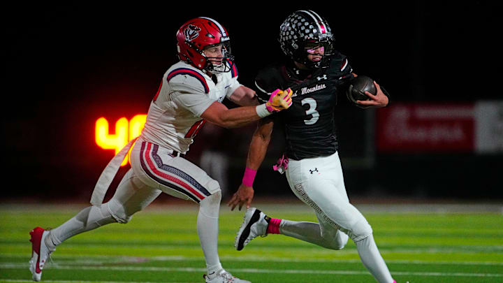 ALA-Queen Creek Brody Michael (12) tackles Red Mountain quarterback Simon Lopez (3) during a game at Red Mountain High School in Mesa on Oct. 18, 2024.