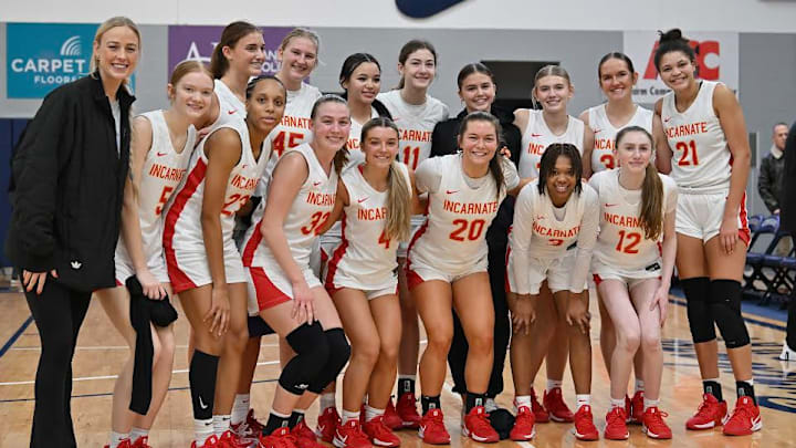 WNBA star Sophie Cunningham (left), a Columbia, Mo. native who currently plays for the Phoenix Mercury, poses with the Incarnate Word girls basketball team after they beat Blue Valley North 68-51 Saturday, Jan. 11, in the Sophie Cunningham Classic in Columbia for their 139th consecutive win - breaking the national all-time consecutive wins record.