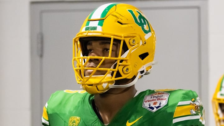 Jan 1, 2024; Glendale, AZ, USA; Oregon Ducks offensive lineman Ajani Cornelius (65) against the Liberty Flames during the 2024 Fiesta Bowl at State Farm Stadium.  