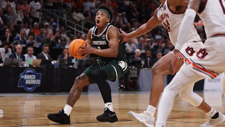 Mar 30, 2025; Atlanta, GA, USA; Michigan State Spartans guard Jeremy Fears Jr. (1) drives against Auburn Tigers center Dylan Cardwell (44) during the second half in the South Regional final of the 2025 NCAA tournament at State Farm Arena. Mandatory Credit: Brett Davis-Imagn Images