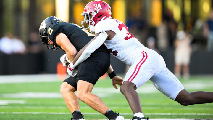 Oct 5, 2024; Nashville, Tennessee, USA;  Alabama Crimson Tide linebacker Que Robinson (34) tackles Vanderbilt Commodores quarterback Diego Pavia (2) during the second half at FirstBank Stadium. Mandatory Credit: Steve Roberts-Imagn Images