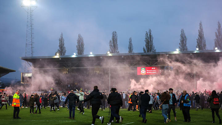 Wrexham's fans couldn't stay off the pitch when celebrating the club's promotion from the National League
