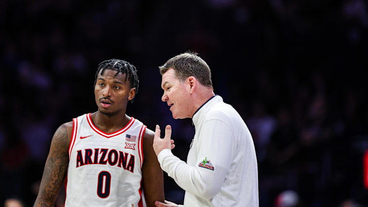 Feb 26, 2025; Tucson, Arizona, USA; Arizona Wildcats head coach Tommy Lloyd talks with guard Jaden Bradley (0) during the second half against the Utah Utes at McKale Center. Mandatory Credit: Aryanna Frank-Imagn Images