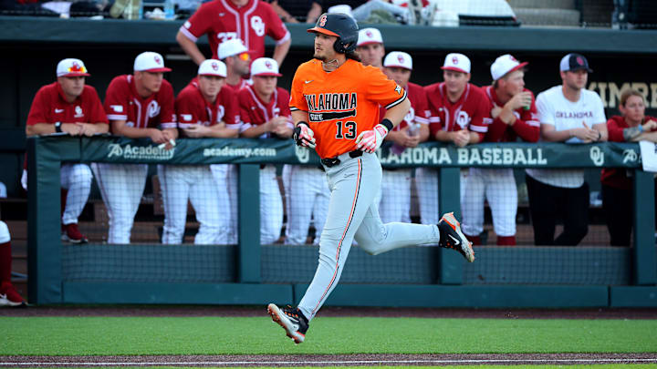 Oklahoma State's Kollin Ritchie (13) runs to home on a home run during the college Bedlam baseball game between the University of Oklahoma Sooners and Oklahoma State University Cowboys in Norman, Okla., Tuesday, March 12, 2024.