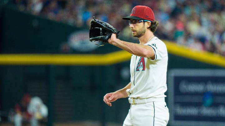 Apr 13, 2025; Phoenix, Arizona, USA;  Arizona Diamondbacks pitcher Zac Gallen (23) calls for the ball while on the mound in the fourth inning against the Milwaukee Brewers at Chase Field. Mandatory Credit: Allan Henry-Imagn Images
