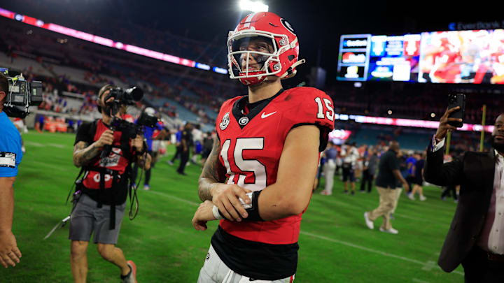 Georgia Bulldogs quarterback Carson Beck (15) walks off the field after the game of an NCAA college football matchup.