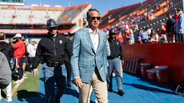 Mississippi Rebels head coach Lane Kiffin walks off the field before a game against the Florida Gators at Ben Hill Griffin Stadium.