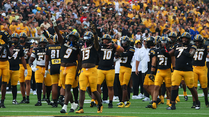 Sep 6, 2025; Columbia, Missouri, USA; Missouri Tigers defense cheers at the video screen showing a Tigers' interception in the second half of the Border War against the Kansas Jayhawks at Faurot Field at Memorial Stadium Sep 6, 2025; Columbia, Missouri, USA; Missouri Tigers defense cheers at the video screen showing a Tigers' interception in the second half of the Border War against the Kansas Jayhawks at Faurot Field at Memorial Stadium