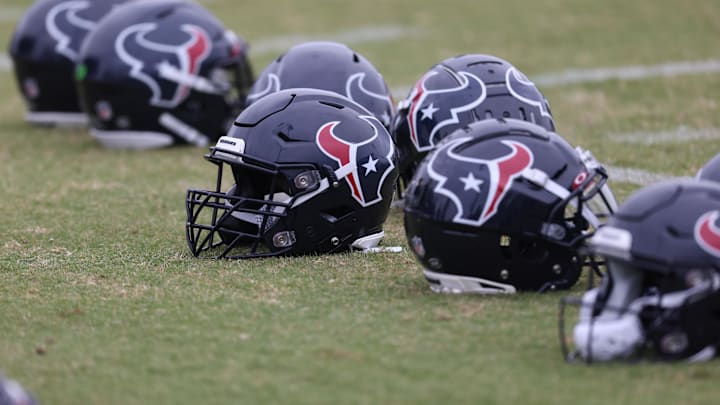 May 24, 2022; Houston, Texas, USA; Houston Texans helmets lay on the turf during organized team activities at the Houston Texans practice field. Mandatory Credit: Thomas Shea-Imagn Images