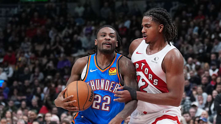 Feb 24, 2026; Toronto, Ontario, CAN; Oklahoma City Thunder guard Cason Wallace (22) dribbles against Toronto Raptors forward Collin Murray-Boyles (12) during the fourth quarter at Scotiabank Arena. Mandatory Credit: Nick Turchiaro-Imagn Images