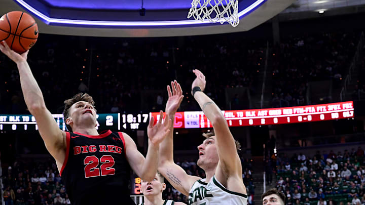 Dec 29, 2025; East Lansing, Michigan, USA;  Michigan State Spartans center Carson Cooper (15) guards Cornell Big Red guard Jake Fiegen (22) during the first half at Jack Breslin Student Events Center. Mandatory Credit: Dale Young-Imagn Images