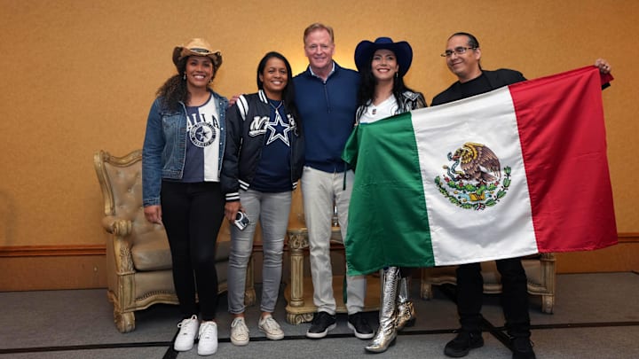 USA women's flag football quarterback Vanita Krouch and Dallas Cowboys fans pose with NFL commissioner Roger Goodell.