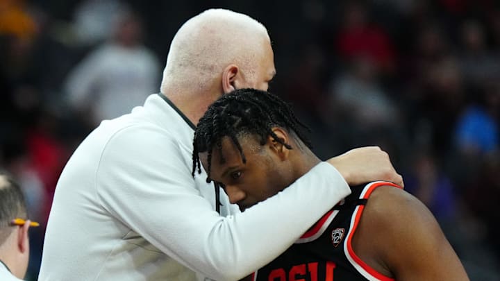 Mar 13, 2024; Las Vegas, NV, USA; Oregon State Beavers coach Wayne Tinkle (left) and guard Dexter Akanno (4) embrace in the second half against the UCLA Bruins at T-Mobile Arena. Mandatory Credit: Kirby Lee-Imagn Images
