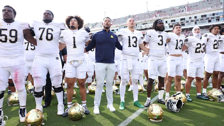 Sep 27, 2025; Fayetteville, Arkansas, USA; Notre Dame Fighting Irish head coach Marcus Freeman leads the team in celebration after the game against the Arkansas Razorbacks at Donald W. Reynolds Razorback Stadium. Notre Dame won 56-13. Mandatory Credit: Nelson Chenault-Imagn Images