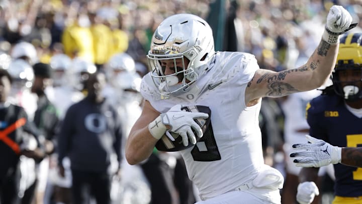 Nov 2, 2024; Ann Arbor, Michigan, USA;  Oregon Ducks tight end Terrance Ferguson (3) is tackled by Michigan Wolverines defensive back Zeke Berry (10) in the first half at Michigan Stadium. Mandatory Credit: Rick Osentoski-Imagn Images