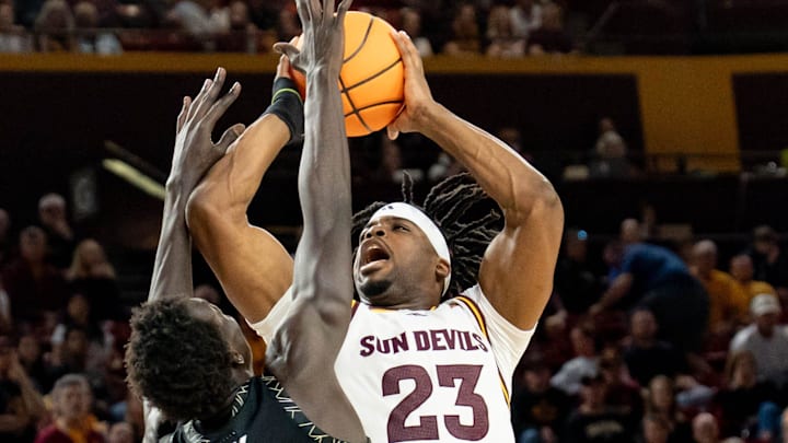 Colorado Buffaloes Bangot Dak (8) attempts to block Arizona State Sun Devils Allen Mukeba (23) during a game at Desert Financial Arena in Tempe, on Jan. 3, 2026. Colorado Buffaloes Bangot Dak (8) attempts to block Arizona State Sun Devils Allen Mukeba (23) during a game at Desert Financial Arena in Tempe, on Jan. 3, 2026.
