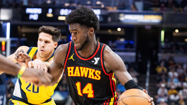 Apr 14, 2024; Indianapolis, Indiana, USA; Atlanta Hawks forward AJ Griffin (14) dribbles the ball while Indiana Pacers forward Doug McDermott (20) defends in the second half at Gainbridge Fieldhouse. Mandatory Credit: Trevor Ruszkowski-USA TODAY Sports