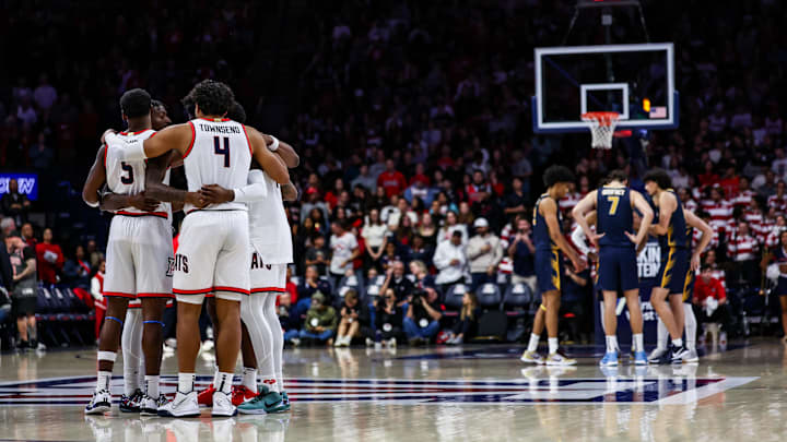 Nov 4, 2024; Tucson, Arizona, USA; Arizona Wildcats players and Canisius Golden Griffins players huddle before the game at McKale Center. Nov 4, 2024; Tucson, Arizona, USA; Arizona Wildcats players and Canisius Golden Griffins players huddle before the game at McKale Center.
