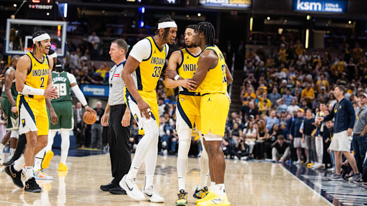 Apr 28, 2024; Indianapolis, Indiana, USA; Indiana Pacers guard Tyrese Haliburton (0) and center Myles Turner (33) hold back forward Aaron Nesmith (23) after a hard foul during game four of the first round for the 2024 NBA playoffs against the Milwaukee Bucks at Gainbridge Fieldhouse. Mandatory Credit: Trevor Ruszkowski-USA TODAY Sports