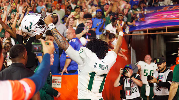 USF quarterback Byrum Brown celebrates the Bulls' historic upset win at Florida.