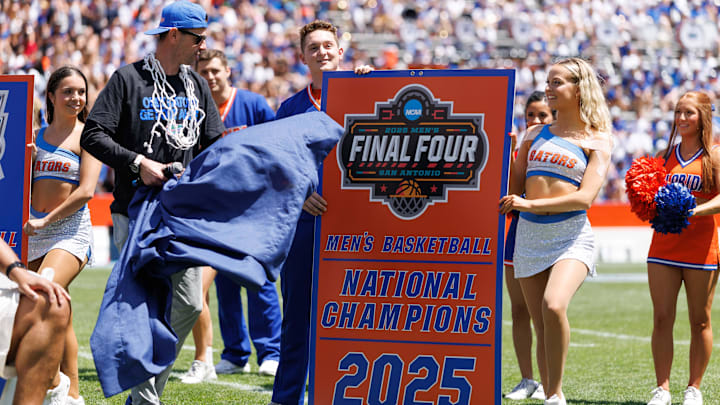 Apr 12, 2025; Gainesville, FL, USA; Florida Gators head coach Todd Golden unveals the National Championship banner during the National Championship celebration at Ben Hill Griffin Stadium. Mandatory Credit: Matt Pendleton-Imagn Images