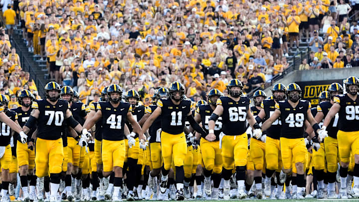 The Iowa Hawkeyes swarm onto the field before the football game against the Massachusetts Minutemen Sept. 13, 2025 at Kinnick Stadium in Iowa City, Iowa.