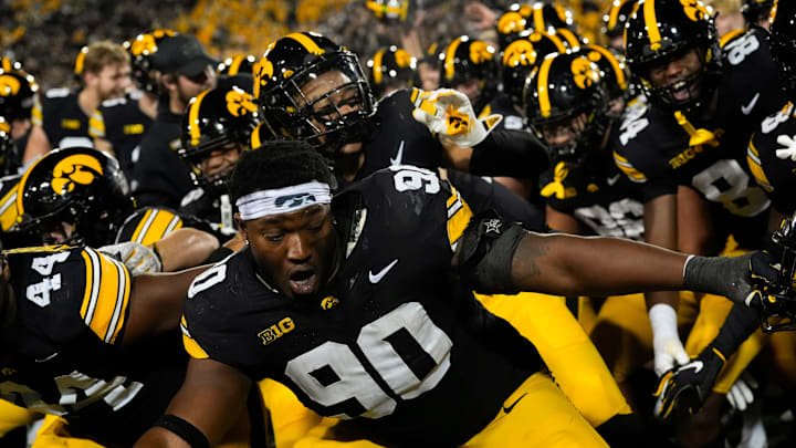 Iowa Hawkeyes defensive lineman Kenneth Merrieweather (44) and Iowa Hawkeyes defensive end Brian Allen (90) celebrate with their teammates after defeating the Penn State Nittany Lions 25-24 Oct. 18, 2025 at Kinnick Stadium in Iowa City, Iowa. Iowa Hawkeyes defensive lineman Kenneth Merrieweather (44) and Iowa Hawkeyes defensive end Brian Allen (90) celebrate with their teammates after defeating the Penn State Nittany Lions 25-24 Oct. 18, 2025 at Kinnick Stadium in Iowa City, Iowa.