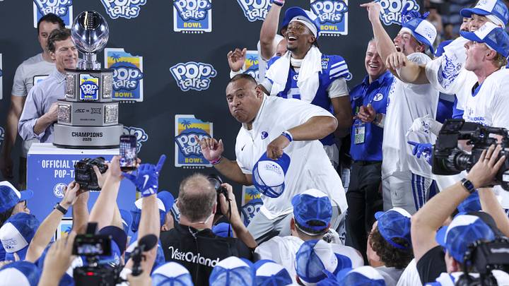 Dec 27, 2025; Orlando, FL, USA; BYU Cougars head coach Kalani Sitake celebrates after beating Georgia Tech Yellow Jackets in the Pop-Tarts Bowl at Camping World Stadium. Mandatory Credit: Nathan Ray Seebeck-Imagn Images