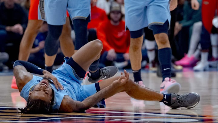 Dec 27, 2024; New Orleans, Louisiana, USA; Memphis Grizzlies guard Ja Morant (12) reacts after a screen by New Orleans Pelicans center Daniel Theis (10) during the third quarter at Smoothie King Center. Mandatory Credit: Matthew Hinton-Imagn Images