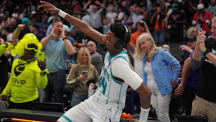 Apr 14, 2026; Charlotte, North Carolina, USA; Charlotte Hornets forward Brandon Miller (24) and fans react to the overtime win during the play-in rounds between the Charlotte Hornets and the Miami Heat of the 2026 NBA Playoffs at Spectrum Center. Mandatory Credit: Jim Dedmon-Imagn Images