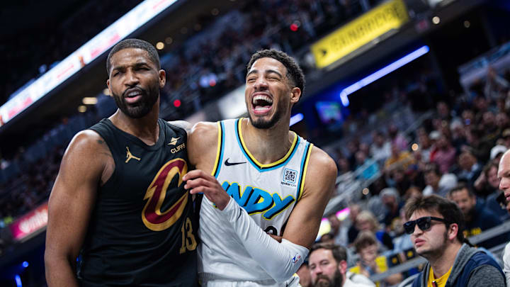 Apr 10, 2025; Indianapolis, Indiana, USA; Cleveland Cavaliers center Tristan Thompson (13) and Indiana Pacers guard Tyrese Haliburton (0) hug it out after a foul in the second half at Gainbridge Fieldhouse. Mandatory Credit: Trevor Ruszkowski-Imagn Images