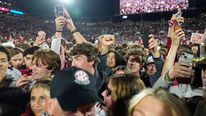Fans rush the field after a college football game between the University of Oklahoma Sooners (OU) and the Alabama Crimson Tide at Gaylord Family - Oklahoma Memorial Stadium in Norman, Okla., Saturday, Nov. 23, 2024. Oklahoma won 24-3.