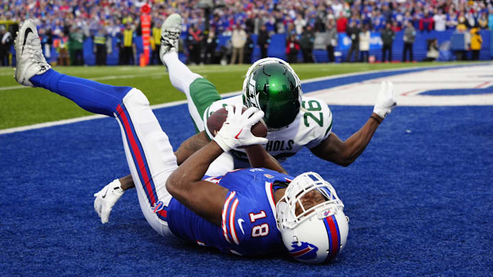 Dec 29, 2024; Orchard Park, New York, USA; Buffalo Bills wide receiver Amari Cooper (18) makes a catch for a touchdown against New York Jets cornerback Brandin Echols (26) during the second half at Highmark Stadium. Dec 29, 2024; Orchard Park, New York, USA; Buffalo Bills wide receiver Amari Cooper (18) makes a catch for a touchdown against New York Jets cornerback Brandin Echols (26) during the second half at Highmark Stadium.