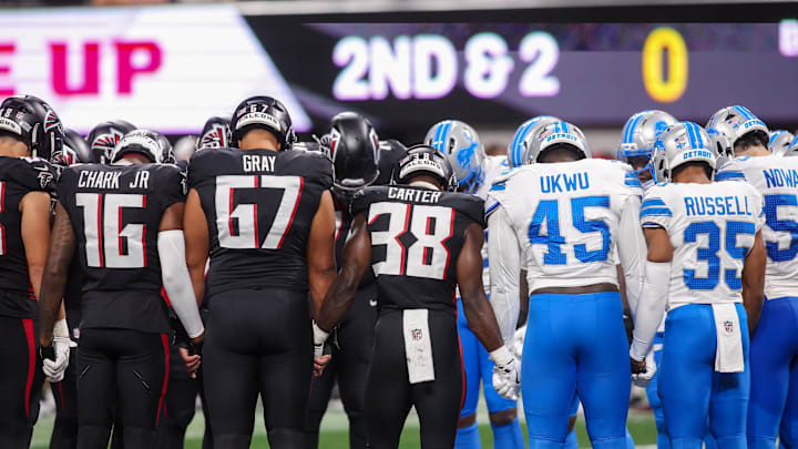 Atlanta Falcons and Detroit Lions players pray after an injury to safety Morice Norris in the fourth quarter at Mercedes-Benz Stadium. 