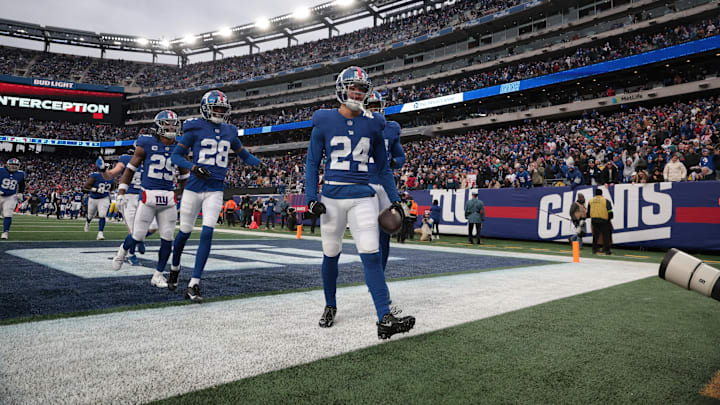 Dec 31, 2023; East Rutherford, New Jersey, USA; New York Giants safety Dane Belton (24) celebrates with teammates after an interception during the second half against the Los Angeles Rams at MetLife Stadium. Dec 31, 2023; East Rutherford, New Jersey, USA; New York Giants safety Dane Belton (24) celebrates with teammates after an interception during the second half against the Los Angeles Rams at MetLife Stadium.