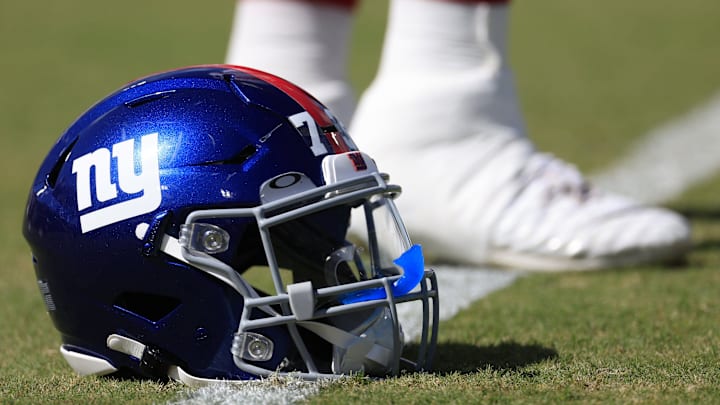 New York Giants offensive tackle Evan Neal (73) stretches next to his helmet before of a regular season NFL football matchup Sunday, Oct. 23, 2022 at TIAA Bank Field in Jacksonville.  
