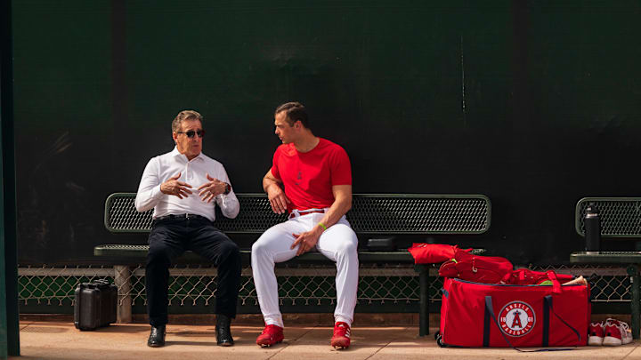 Feb 19, 2023; Tempe, AZ, USA; Los Angeles Angels team owner Arturo  Arte  Moreno (left) speaks with catcher Logan O Hoppe (14) during spring training workouts at Tempe Diablo Stadium. Mandatory Credit: Allan Henry-Imagn Images