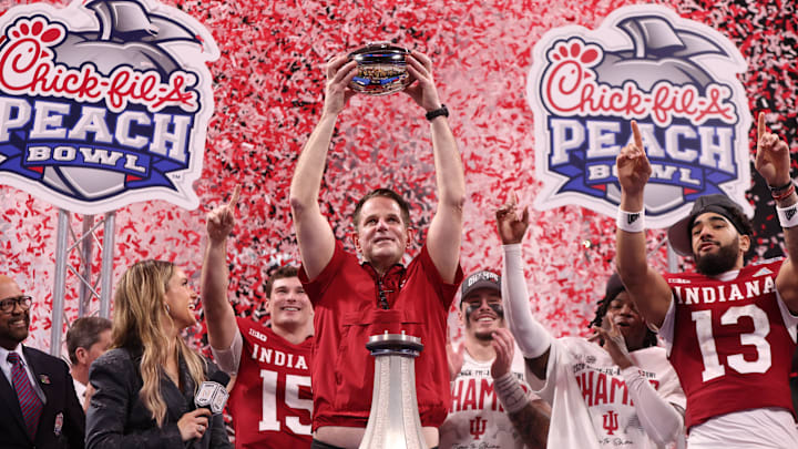 Indiana Hoosiers head coach Curt Cignetti raises the Peach Bowl trophy after defeating the Oregon Ducks at Mercedes-Benz Stadium. 
