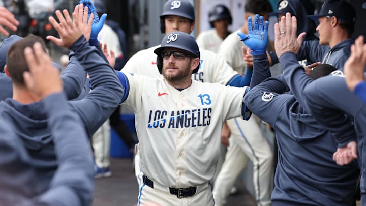 Apr 25, 2026; Los Angeles, California, USA; Los Angeles Dodgers infielder Max Muncy (13) and designated hitter Shohei Ohtani (17) shake hands with teammates in the dugout after a two run home run against the Chicago Cubs during the third inning at Dodger Stadium. Mandatory Credit: Kiyoshi Mio-Imagn Images