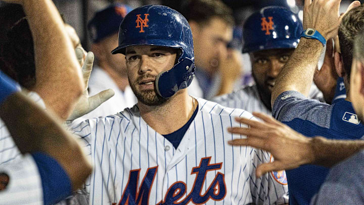 Sep 11, 2018; New York City, NY, USA; New York Mets catcher Kevin Plawecki (26) is congratulated in the dugout by teammates after hitting a home run during the ninth inning of the game against the Miami Marlins at Citi Field. Mandatory Credit: Gregory J. Fisher-Imagn Images