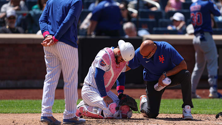 May 11, 2025; New York City, New York, USA; New York Mets catcher Luis Torrens (13) is looked at by medical staff after being hit by a foul ball by Chicago Cubs right fielder Kyle Tucker (not pictured) during the sixth inning at Citi Field. Torrens would leave the game due to an injury after the play. Mandatory Credit: Vincent Carchietta-Imagn Images