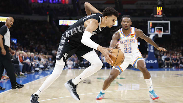Oct 30, 2024; Oklahoma City, Oklahoma, USA; San Antonio Spurs center Victor Wembanyama (1) drives to the basket beside Oklahoma City Thunder guard Cason Wallace (22) during the second quarter at Paycom Center.